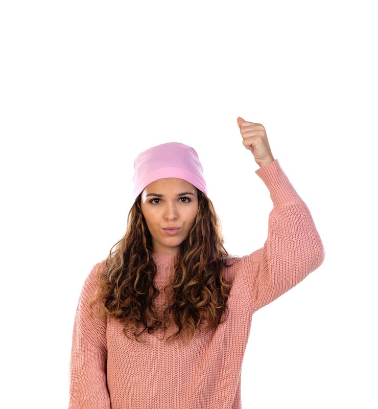 Foto mulher esperançosa com câncer usando um lenço rosa atencioso isolado em uma parede branca