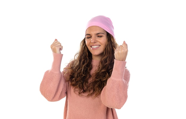 Mulher esperançosa com câncer usando um lenço rosa atencioso isolado em uma parede branca