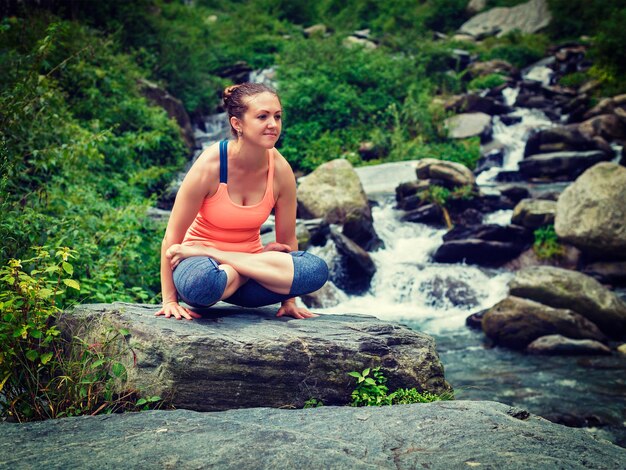 Foto mulher fazendo ashtanga vinyasa yoga asana de equilíbrio do braço tolasana