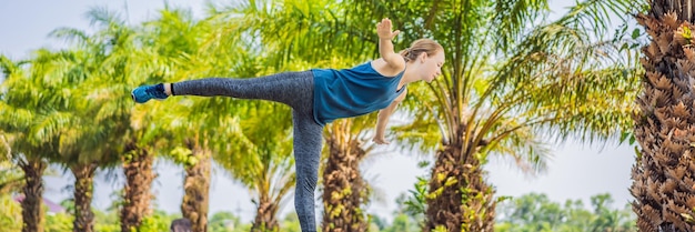 Mulher fazendo ioga em um formato longo de banner de parque tropical