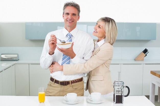 Mulher feliz abraçando homem na cozinha