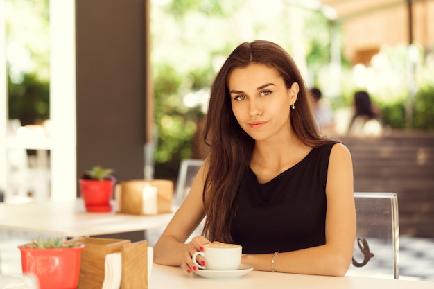 Mulher feliz no café ao ar livre