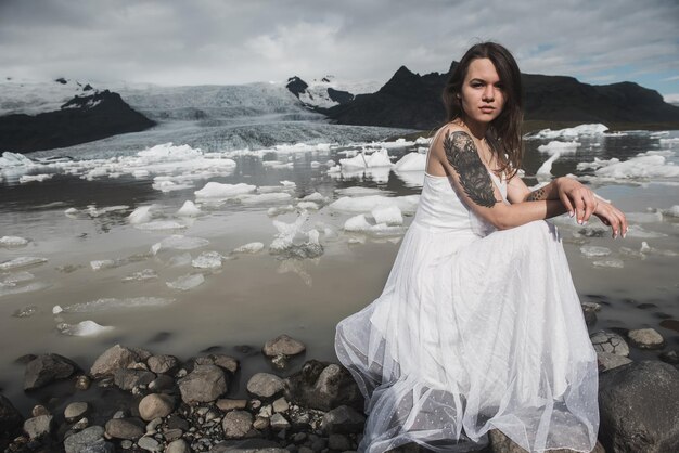 Mulher fica no contexto das geleiras na Islândia