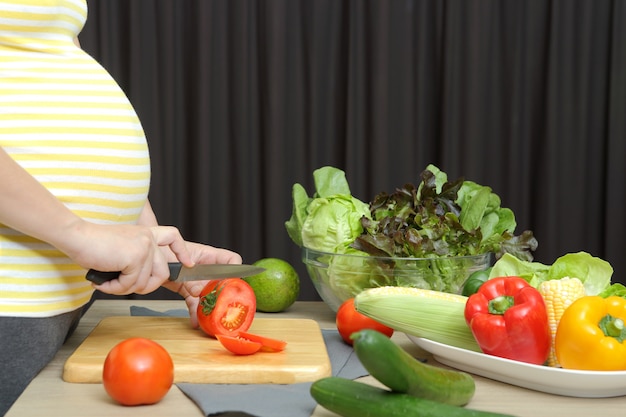 Mulher grávida está cozinhando