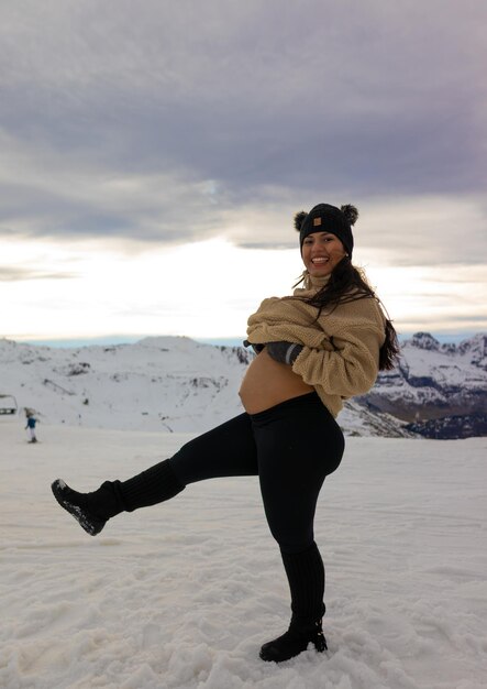 Mulher grávida feliz na neve