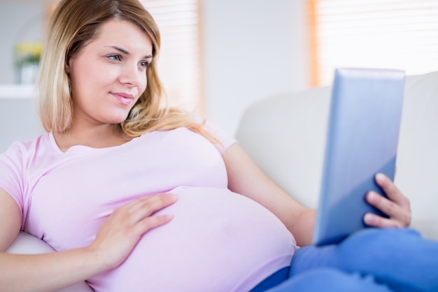 Mulher grávida usando tableta
