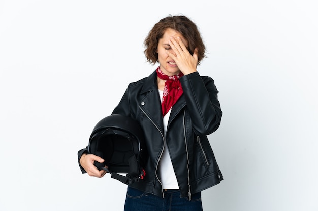 Mulher inglesa segurando um capacete de motociclista isolado com uma expressão cansada e doente