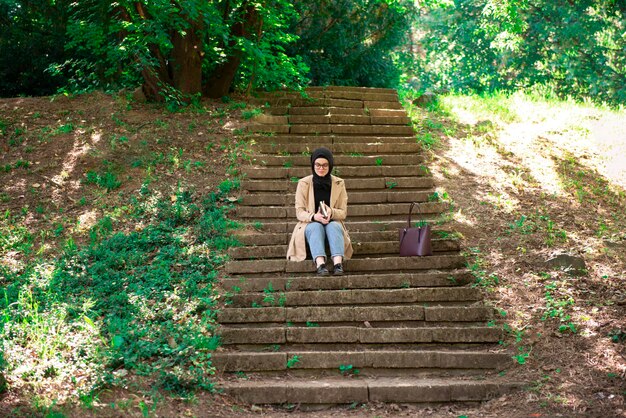 Mulher inteligente navegando em um livro no parque