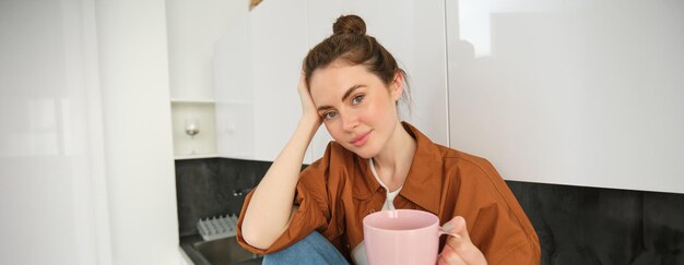 Foto mulher jovem a beber café em casa.