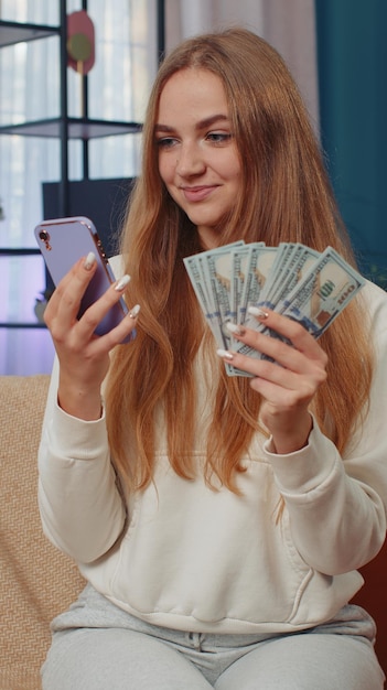 Foto mulher jovem a usar telemóvel.