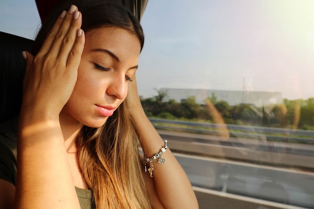 Mulher jovem adoece durante uma viagem de ônibus. mulher de turista de enjôo no ônibus com dor de cabeça ou náuseas.