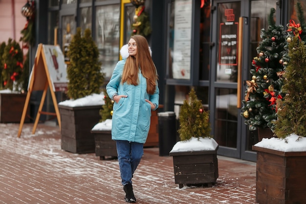 Mulher jovem caminhando no parque de inverno