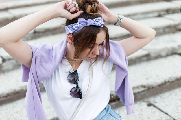 Mulher jovem com roupas da moda primavera roxa na rua