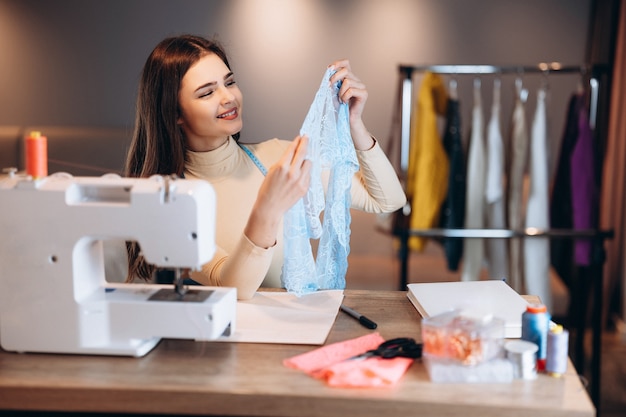 Mulher jovem costureira com máquina de costura