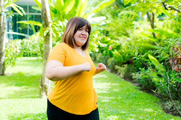 Foto mulher jovem de pé contra plantas amarelas