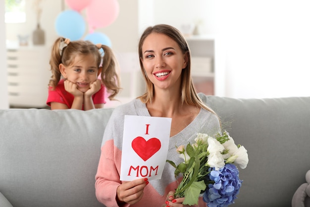 Mulher jovem e bonita com presentes da filha em casa