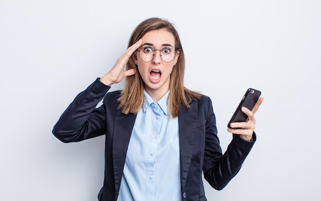 Mulher jovem e bonita parecendo feliz, espantada e surpresa. conceito de negócios