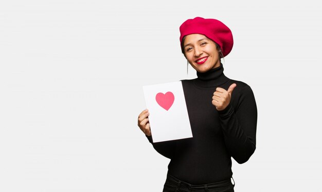 Mulher jovem, em, dia dos namorados, sorrindo, e, levantamento, polegar cima