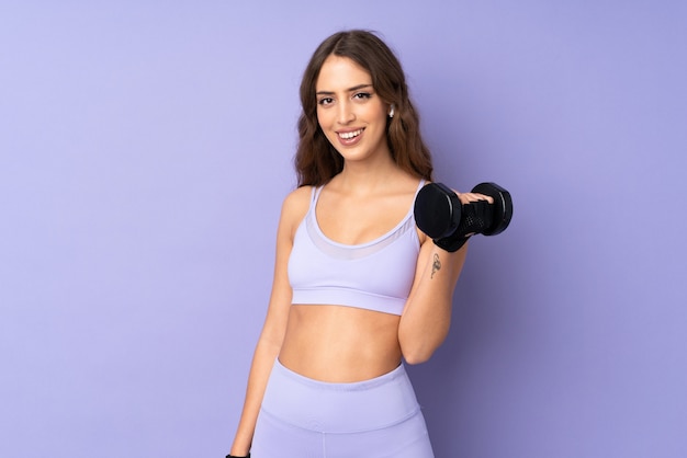 Mulher jovem esporte roxo parede fazendo halterofilismo