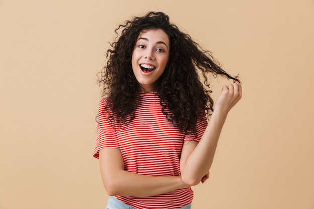 Foto mulher jovem feliz isolada sobre uma parede bege