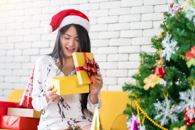 Mulher jovem feliz segurando um chapéu em uma caixa