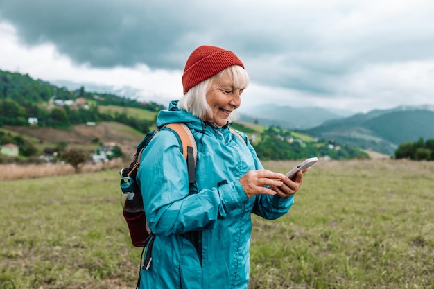 Mulher jovem mão com smartphone pegando sinal em montanhas viagem de estrada transporte tecnologia de viagem