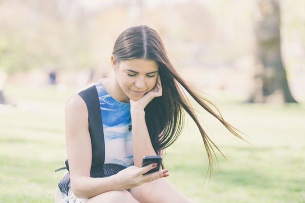 Mulher jovem, olhar, esperto, telefone, em, parque, em, londres