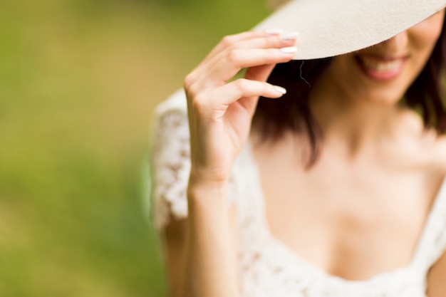 Mulher jovem, posar, em, um, vestido branco, com, um, chapéu