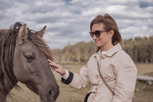 Mulher jovem se comunica com cavalo