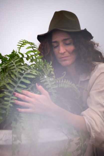 Foto mulher jovem segurando planta