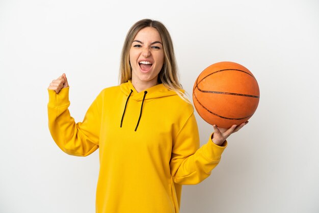 Mulher jovem sobre fundo branco isolado jogando basquete