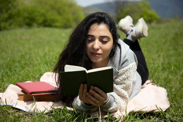 Mulher lendo livros na natureza