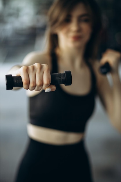 Mulher levantando halteres na academia