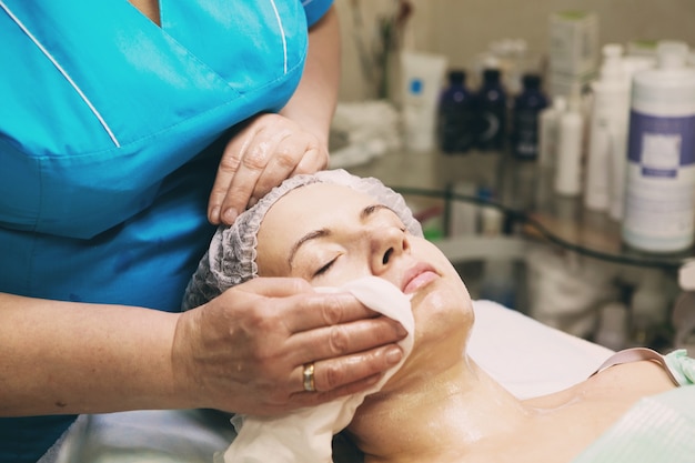 Mulher linda garota natural no salão spa, faz uma máscara facial, procedimento de rejuvenescimento facial, tratamentos de spa