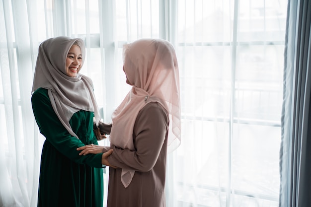 Mulher muçulmana hijab felizmente conhece sua irmã