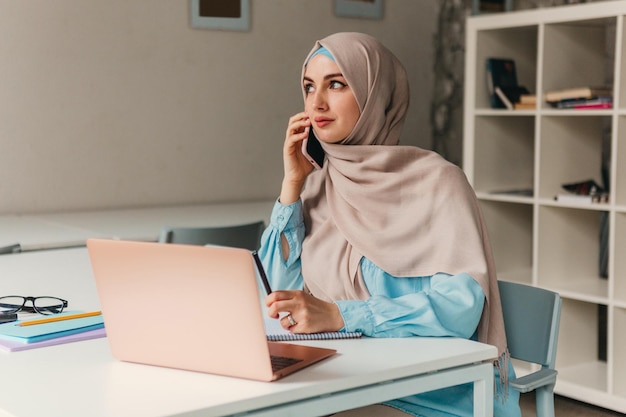 Mulher muçulmana moderna em hijab na sala de escritório