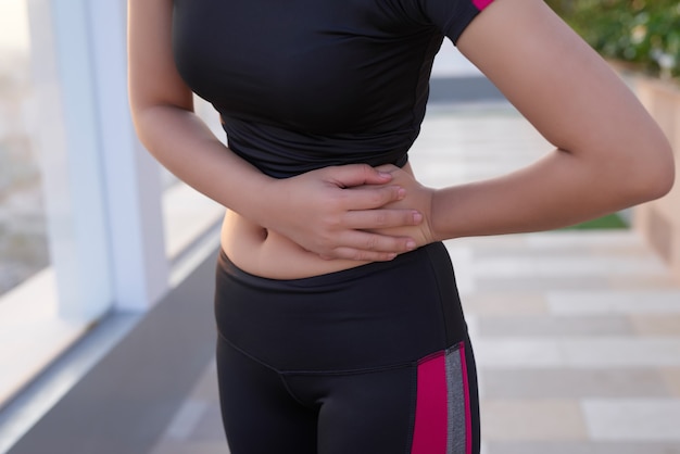 Mulher musculosa com dor de estômago