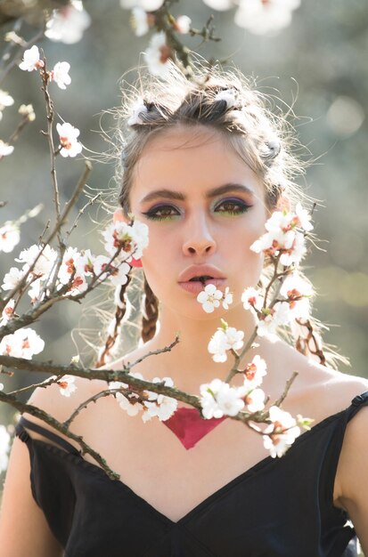 Mulher na bela flor da primavera floresce no jardim