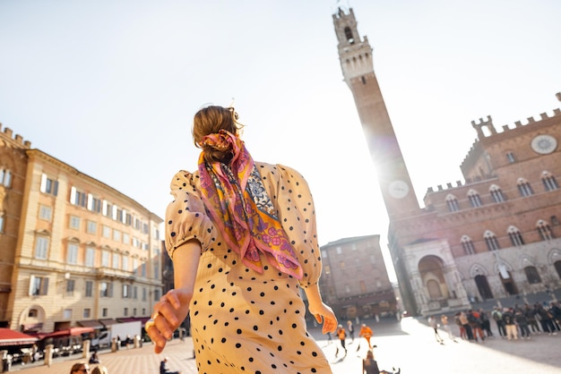 Mulher na praça principal da cidade de siena, na itália