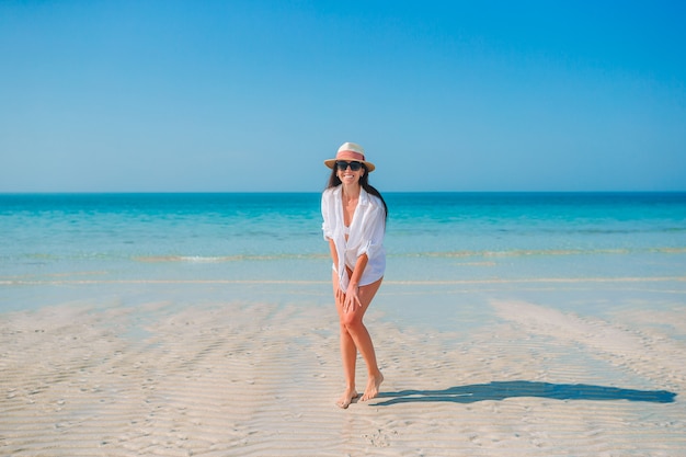 Mulher na praia aproveitando as férias de verão