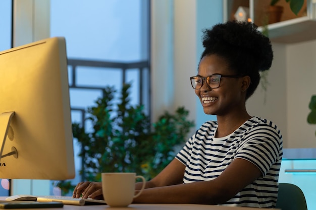 Mulher negra feliz e bem-sucedida gosta de trabalhar em casa em site remoto ou freelancer ou projeto de aplicativo