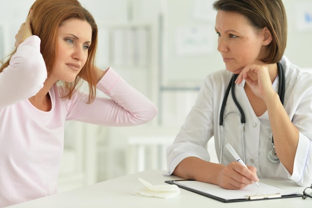 Mulher no hospital com médico atencioso