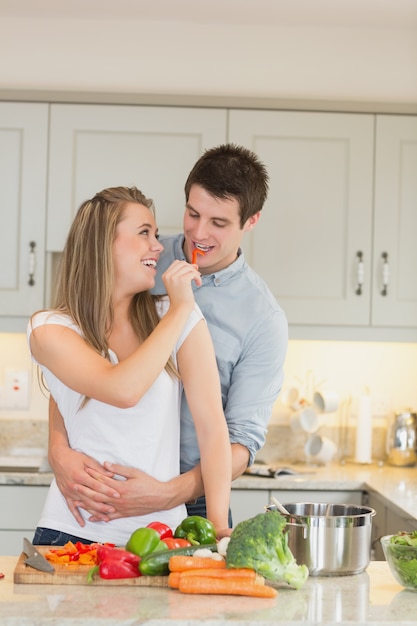 Mulher que alimenta o homem com uma pimenta