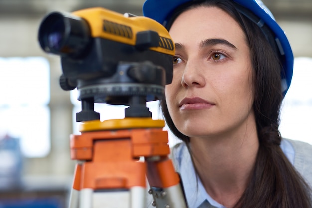 Mulher que trabalha em topografia de construção