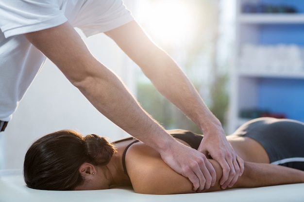 Mulher recebendo massagem nos braços do fisioterapeuta
