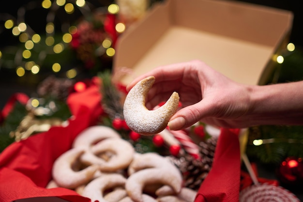 Mulher segurando o biscoito kipferl de baunilha tradicional alemão ou austríaco vanillekipferl