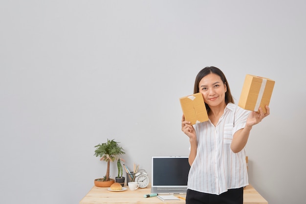 Mulher segurando um pacote, pme de negócios, inicialização on-line