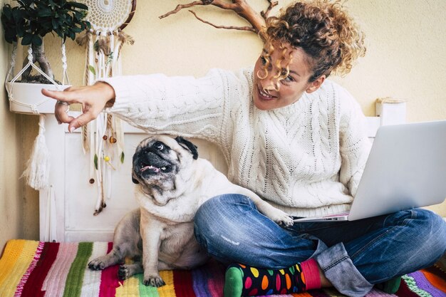 Mulher sentada na varanda com seu amigo pug passando um tempo acariciando