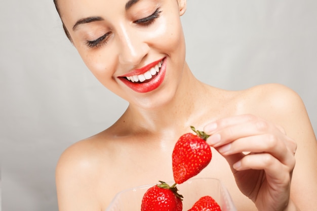 Foto mulher sexy comendo morango. lábios sensuais.