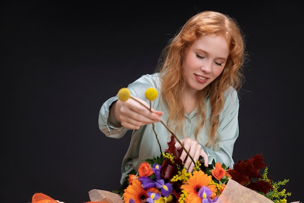 Foto mulher sorridente com tiro médio segurando flores